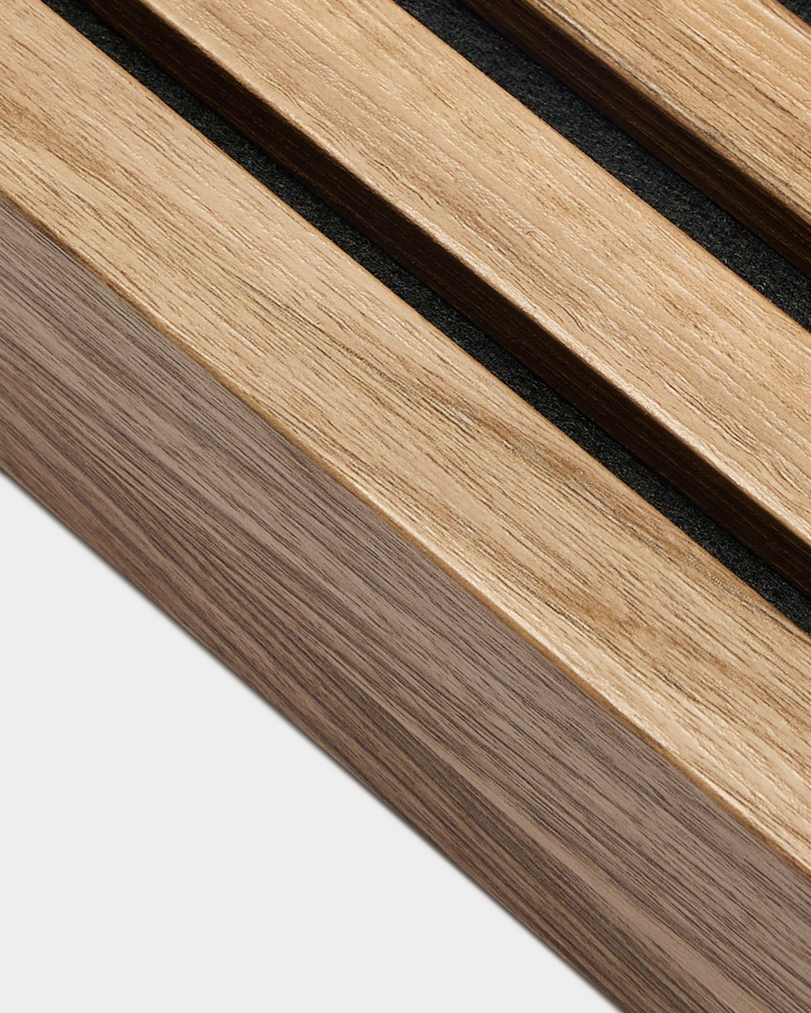 Plano aproximado da lamela terminal WoodUpp Akupanel em Nogueira Inglesa (6,7 cm), mostrando black espaços entre as ripas acústicas sobre um fundo branco liso.